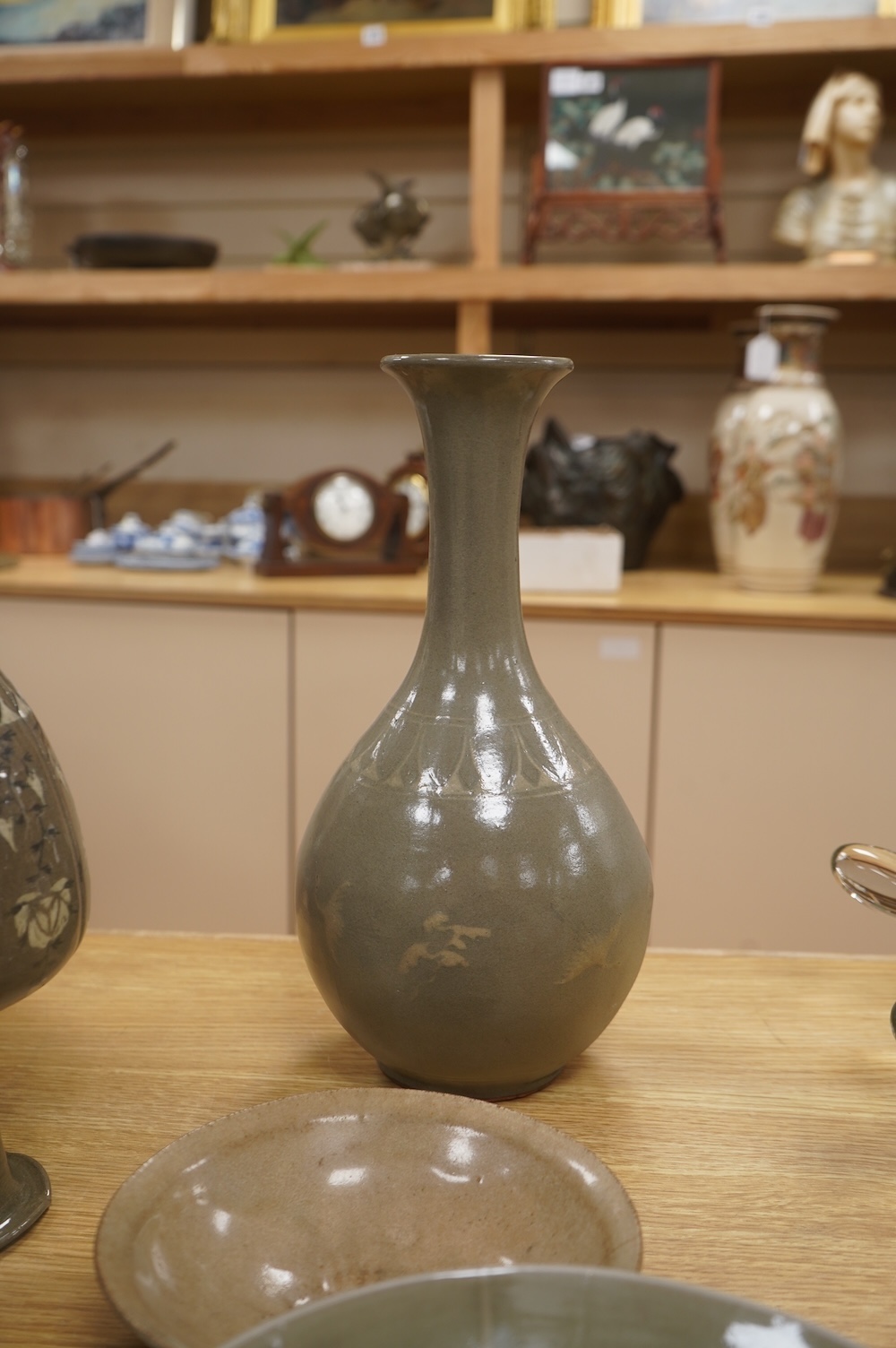 Five pieces of Chinese/Korean celadon comprising three bowls and two vases, 31cm high. Condition - some breaks